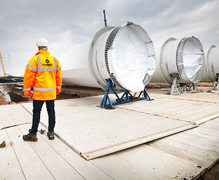 Engineer Stood Next To Wind Turbines Lay Flat