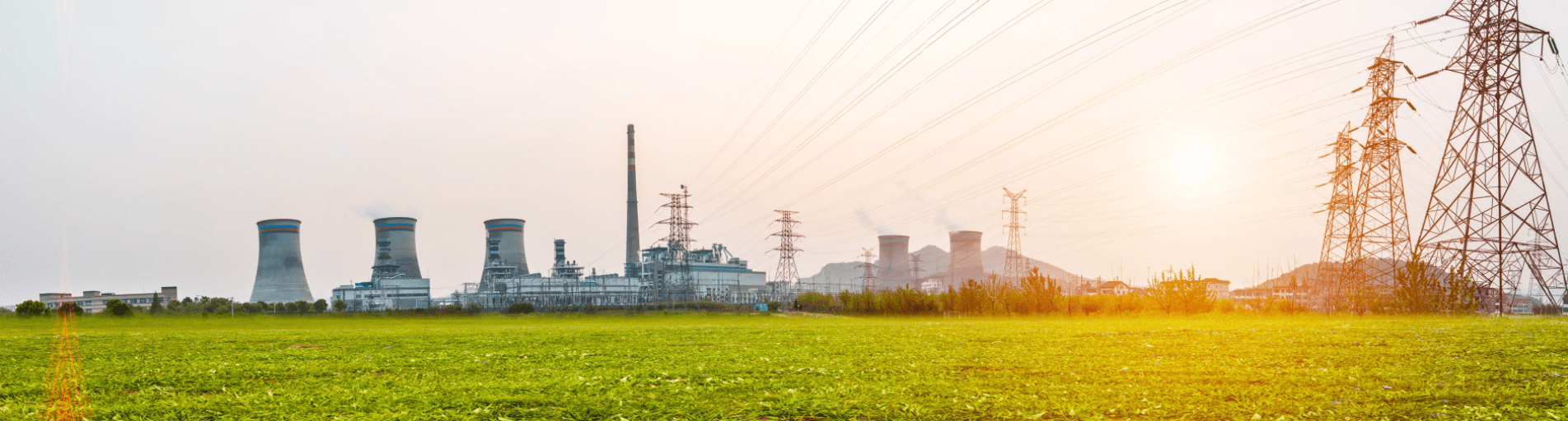 Sunset view of power station next to field