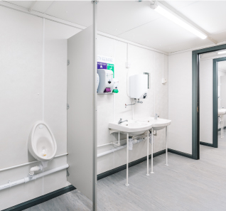 white interior of a toilet & shower cabin unit