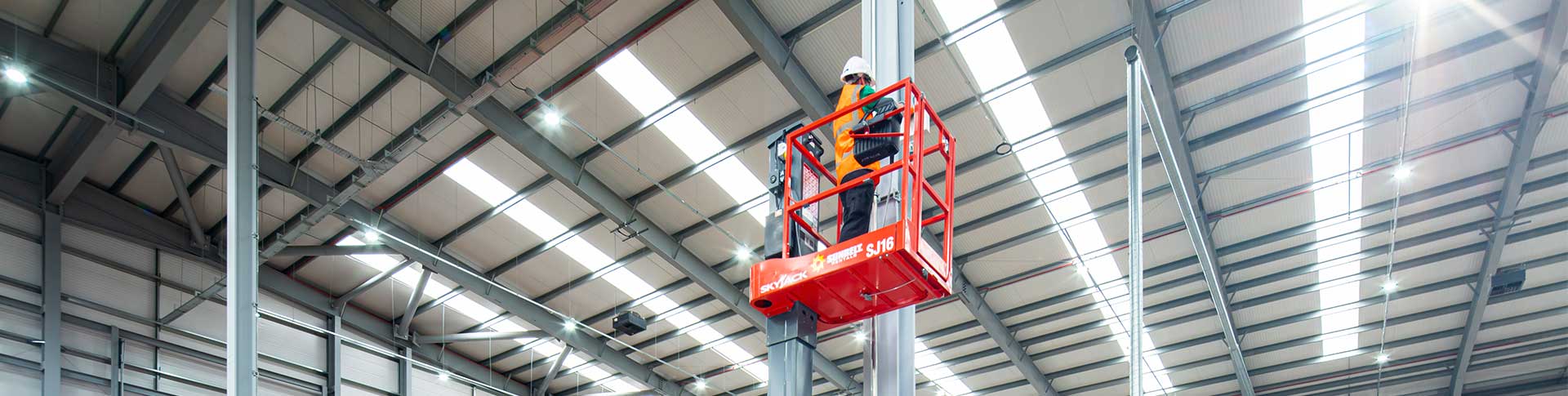 Man Standing On Low Level Access Platform On Site At A Sigma Retail Solutions Location In Warehouse