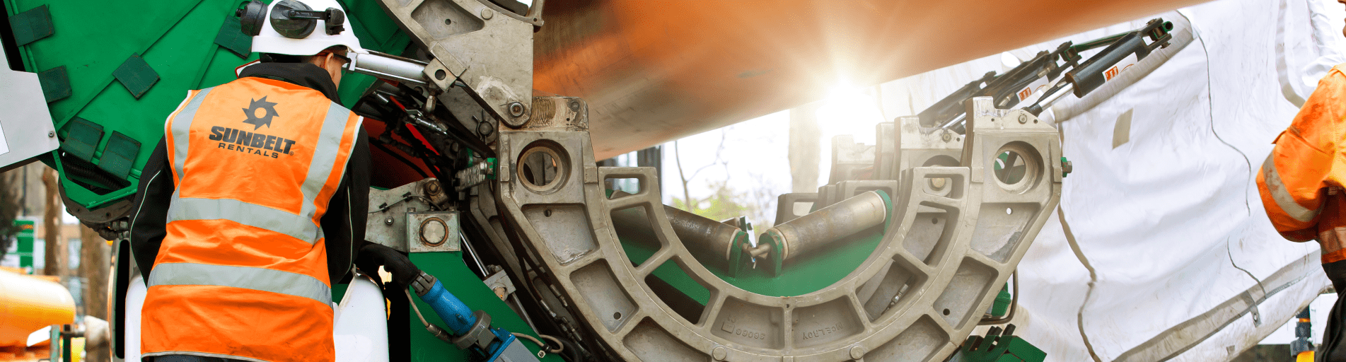 Sunbelt Rentals employee working on utilities pipes